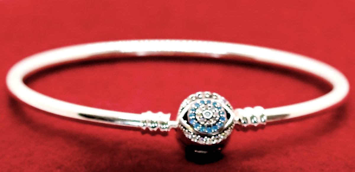 Sterling Silver Bangle Charm Bracelet with Humes Hand, Evil Eye Solid Bead & Hanging Evil Eye Charms. Bracelet is Accented with Uniquely Designed Round Clasp with Blue CZ