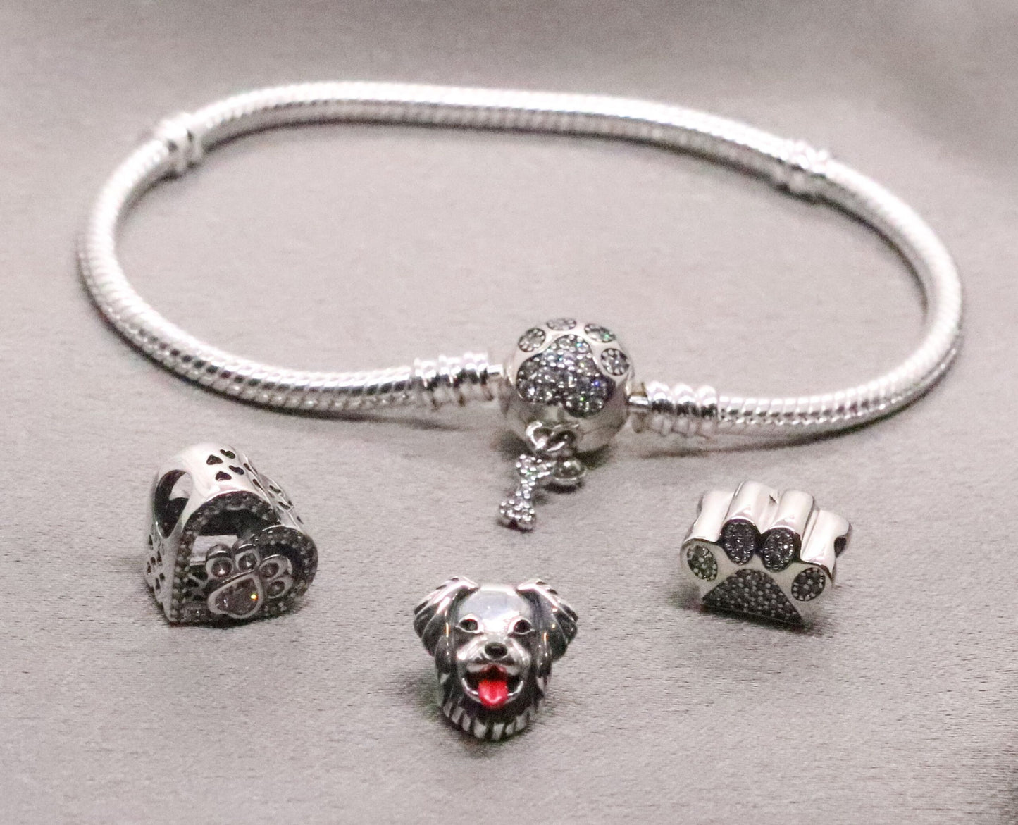 Elegant Sterling Silver Snake Charm Bracelet with Engraved Paw and Bone Charms