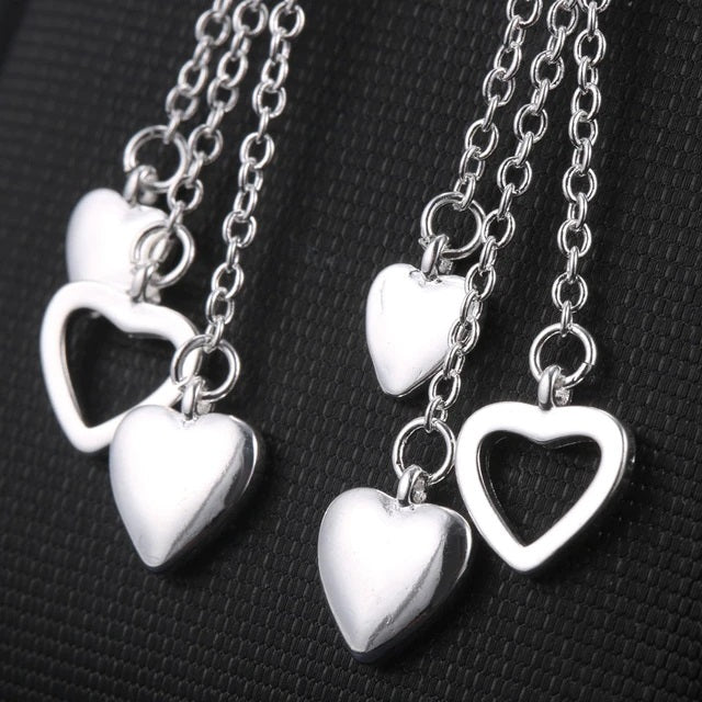 Elegantly Designed Sterling Silver Earrings with Dangling Open and Solid Hearts