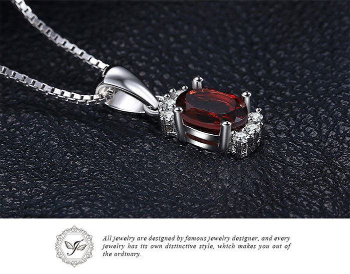 Sterling Silver Oval Shaped Natural Garnet Accented with Six Cubic Zirconia Stones on 18" Box Chain. Origin of Stone Mozambique