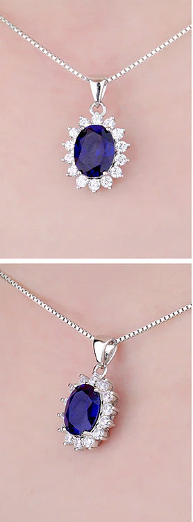 Sterling Silver Oval Shaped Lab Created Non-Treated Sapphire Accented with 14 Round Cubic Zirconia Stones on 18" Box Chain. Origin of Stone Switzerland