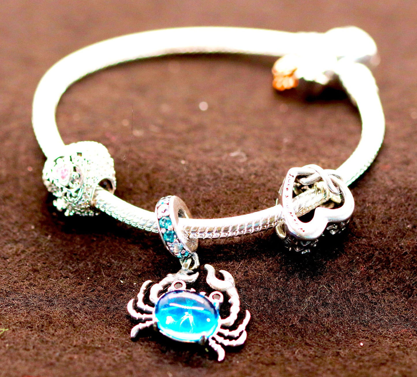 Sterling Silver Flexible Snake Charm Bracelet with Crab Accented with Blue Stone, Open Heart Charm, And Solid Heart Shaped Bead Charms Accented with High Polished Clasp CZ &amp; Two Hanging Leaves