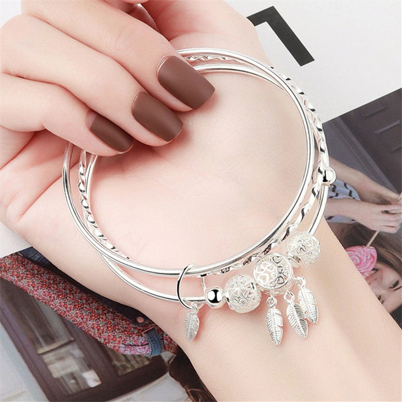 Sterling Silver Slip-on 3 Bangle Bracelet With 5 Diamond Cut Beads And 4 Hanging Feathers