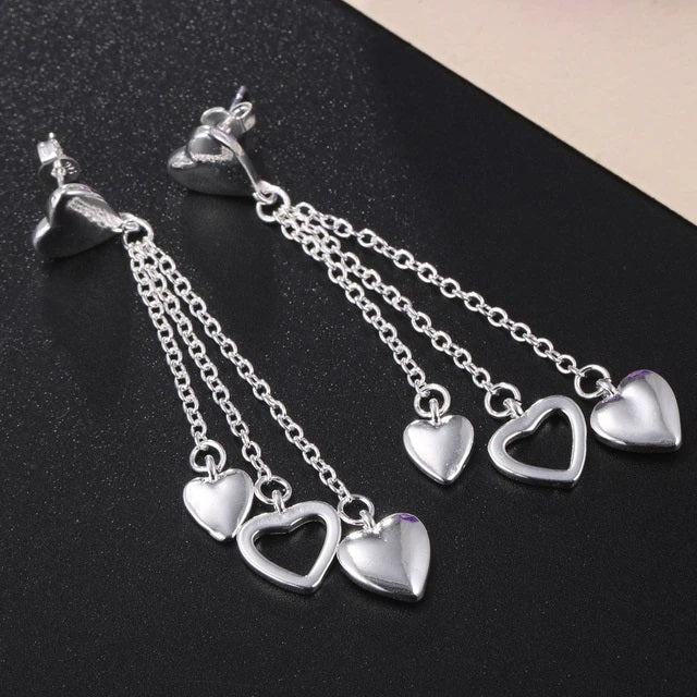 Elegantly Designed Sterling Silver Earrings with Dangling Open and Solid Hearts