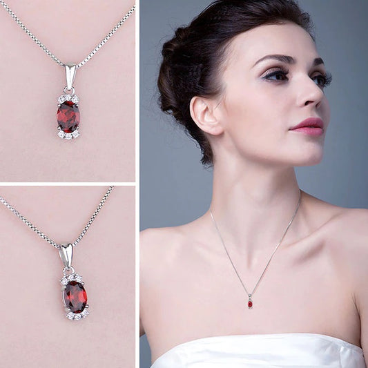 Sterling Silver Oval Shaped Natural Garnet Accented with Six Cubic Zirconia Stones on 18" Box Chain. Origin of Stone Mozambique